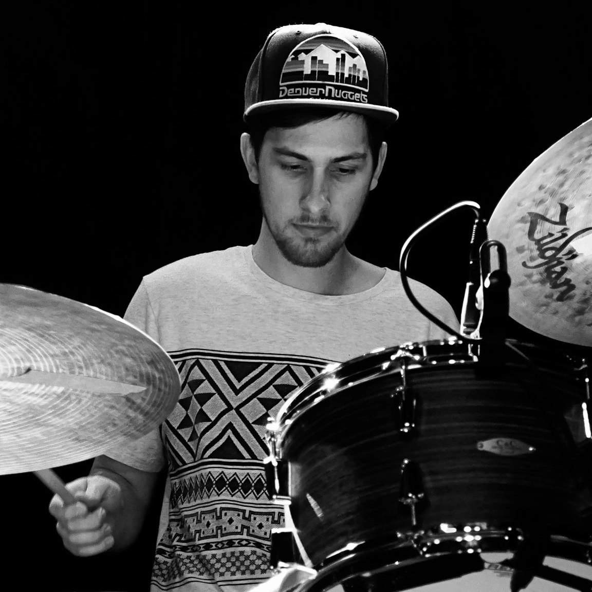 mason playing the drums in black & white