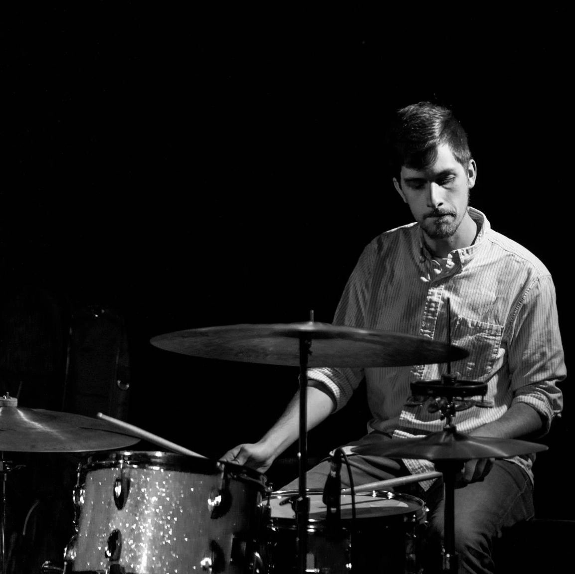 mason playing the drums in black & white