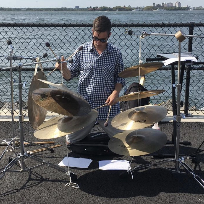 mason playing a bunch of cymbals at Inuksuit